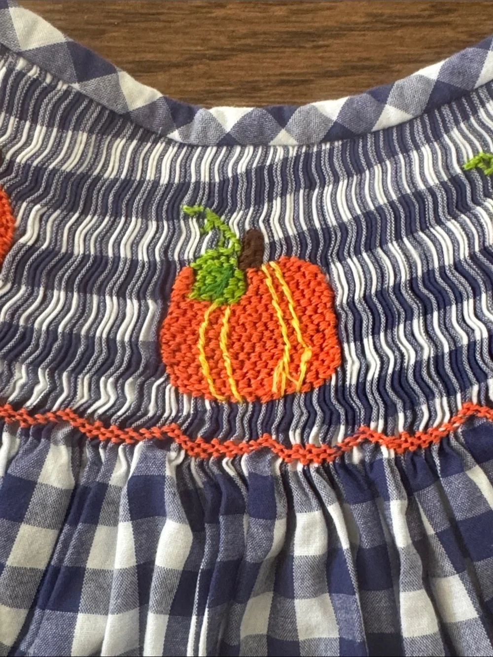Cecil And Lou Navy Gingham Smocked Dress with Smocked Orange Pumpkin Embroidery